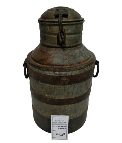 Antique metal milk can with rust