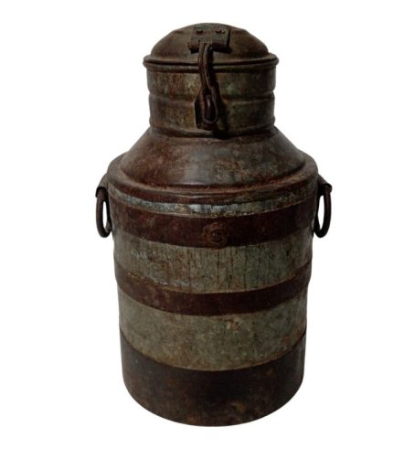Antique metal milk can with rust